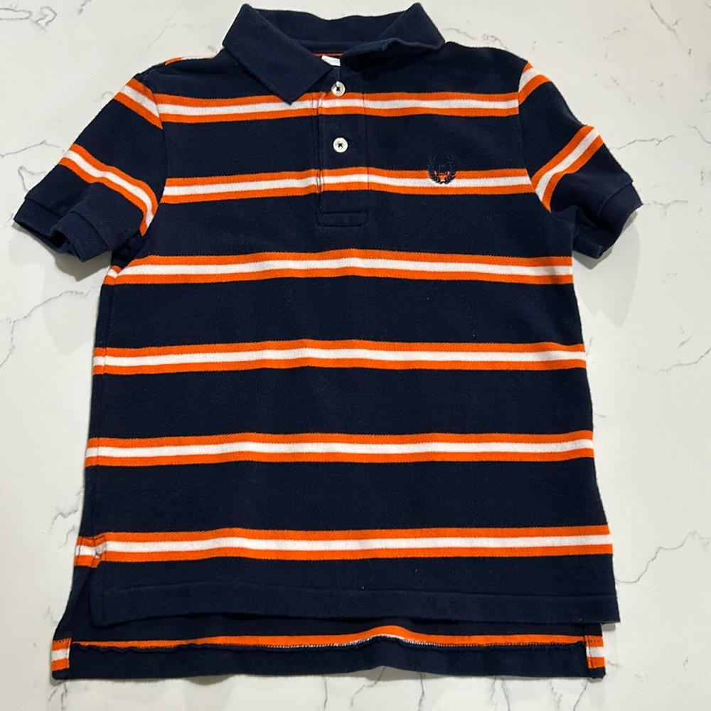 Little boy’s navy, orange and white Chapstick polo